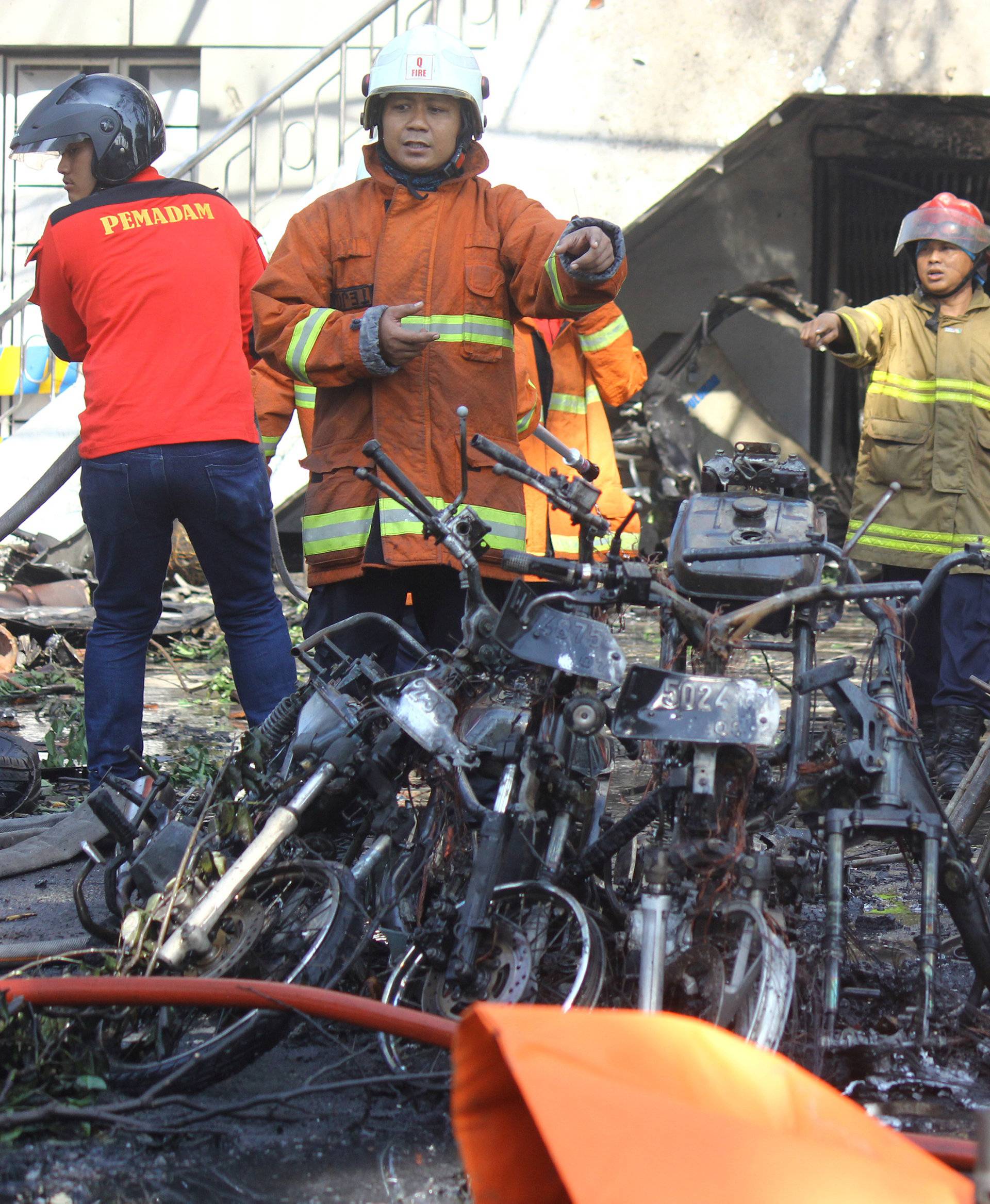 Firefighters are seen at thesite of a blast at the Pentecost Church Central Surabaya (GPPS), in Surabaya, East Java
