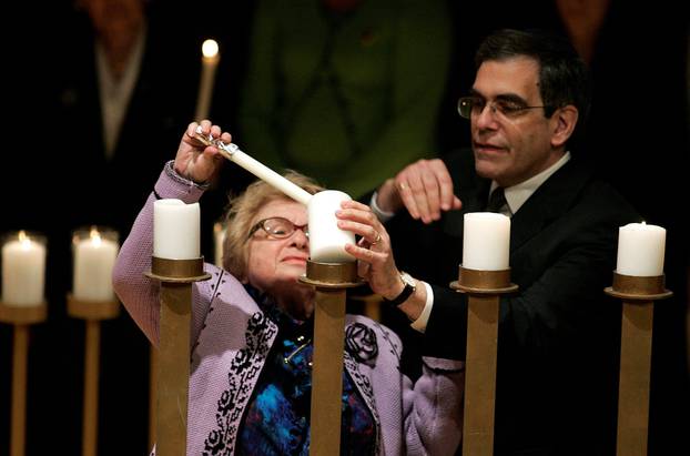 FILE PHOTO: Holocaust survivor Westheimer lights a candle during the Annual Gathering of Remembrance in New York