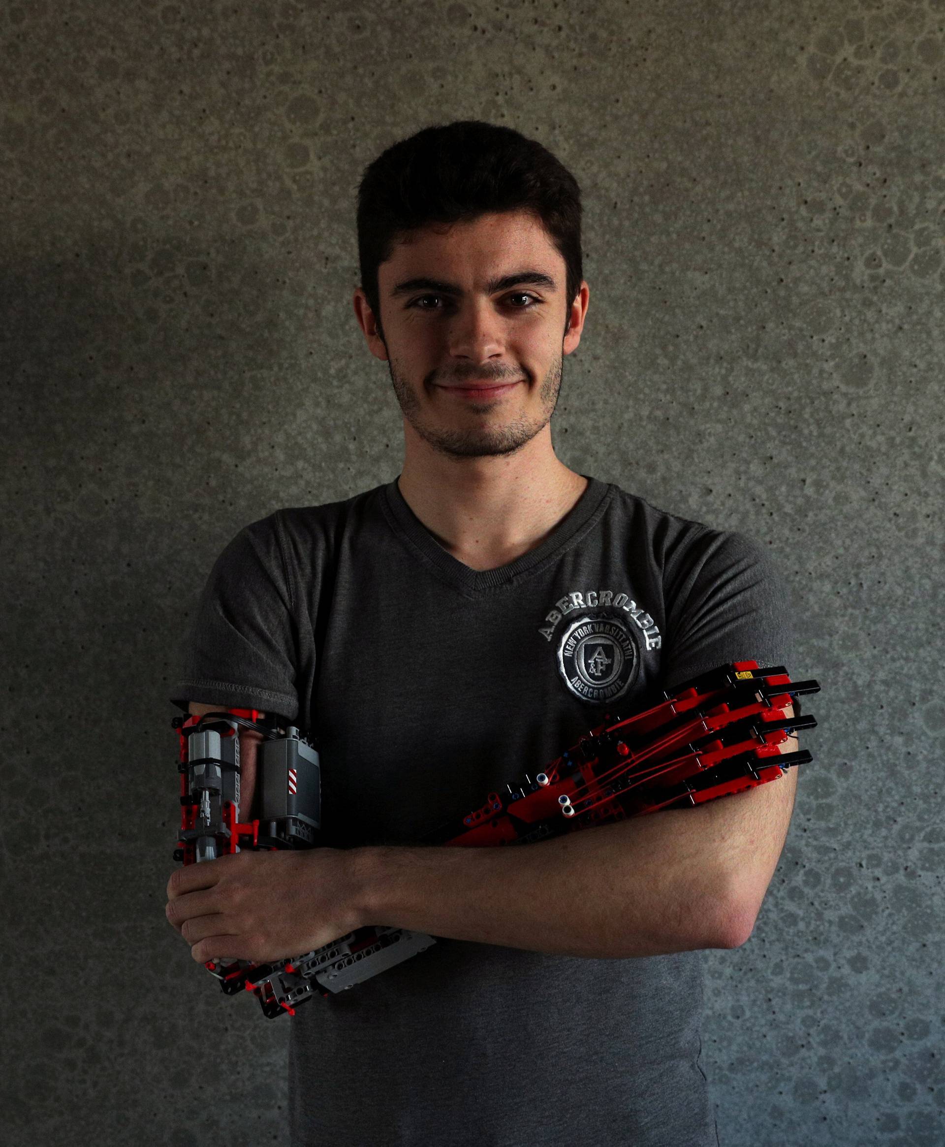 David Aguliar poses with his prosthetic arm built with Lego pieces during an interview with Reuters in Sant Cugat del Valles