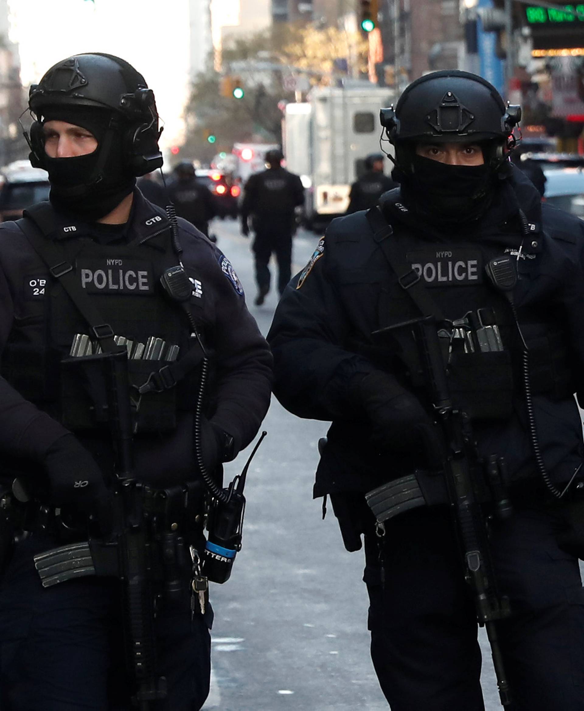 Police officers stand on a closed West 42nd Street near the New York Port Authority Bus Terminal after reports of an explosion in New York City