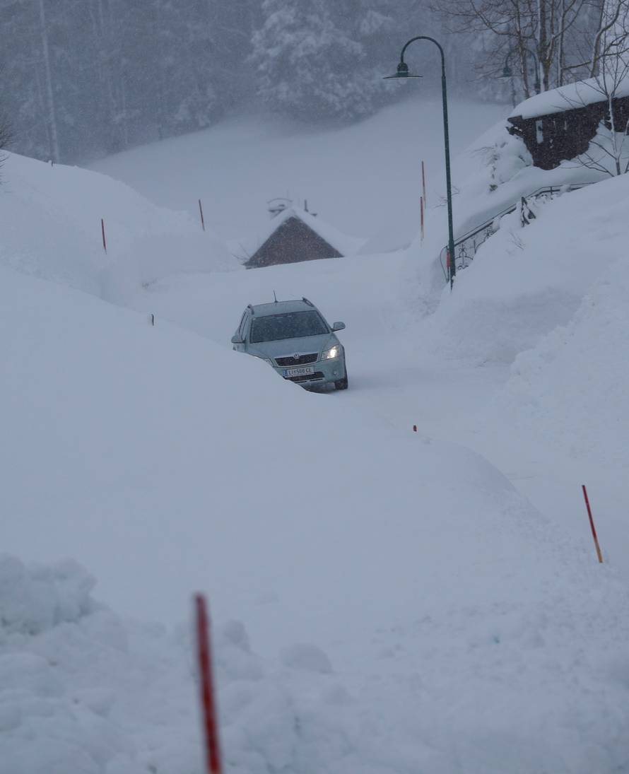 A car drives on an icy road after heavy snowfall in Knoppen