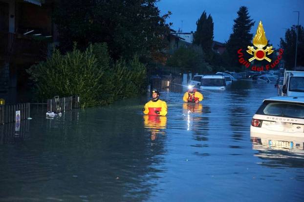 Italian firefighters work in flooded streets in Tuscany region