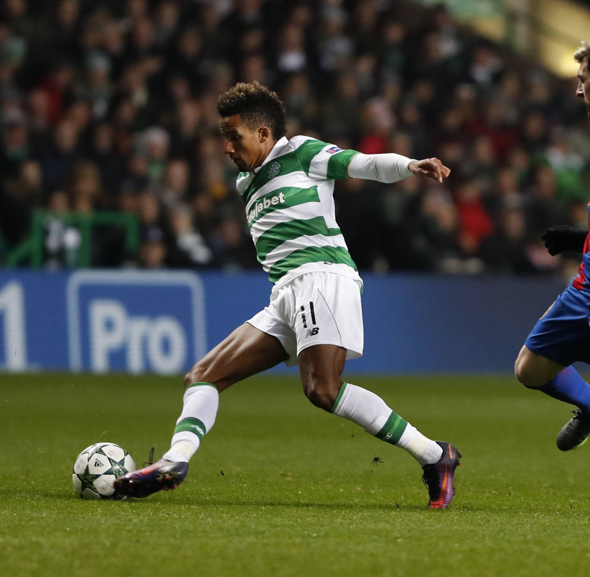 Celtic's Scott Sinclair in action with Barcelona's Lionel Messi