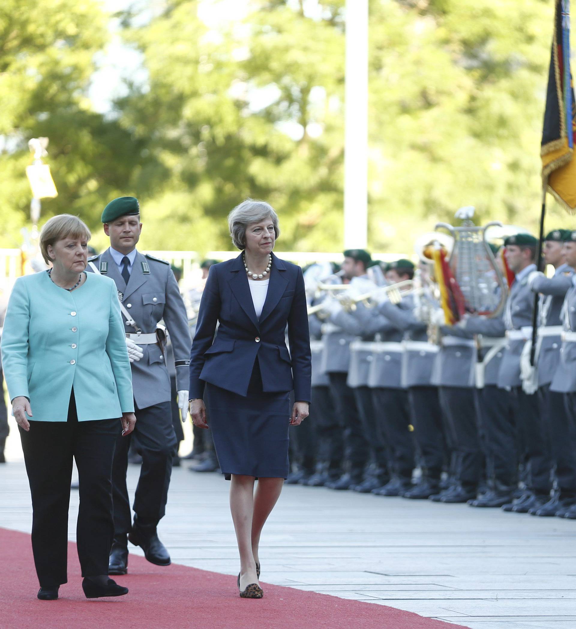 German Chancellor Merkel and Britain's Prime Minister May review honour guard in Berlin