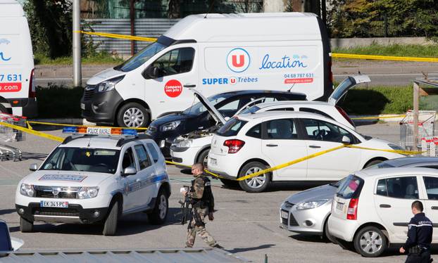 Police officers and investigators at a supermarket after a hostage situation in Trebes