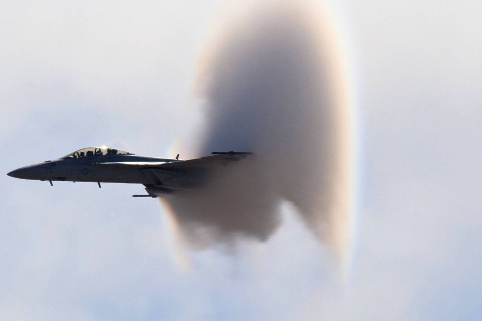 F-18 Super Hornet supersonic jet creates conical vapour trail as it breaks sound barrier, San Diego, California, America - 21 Jan 2011
