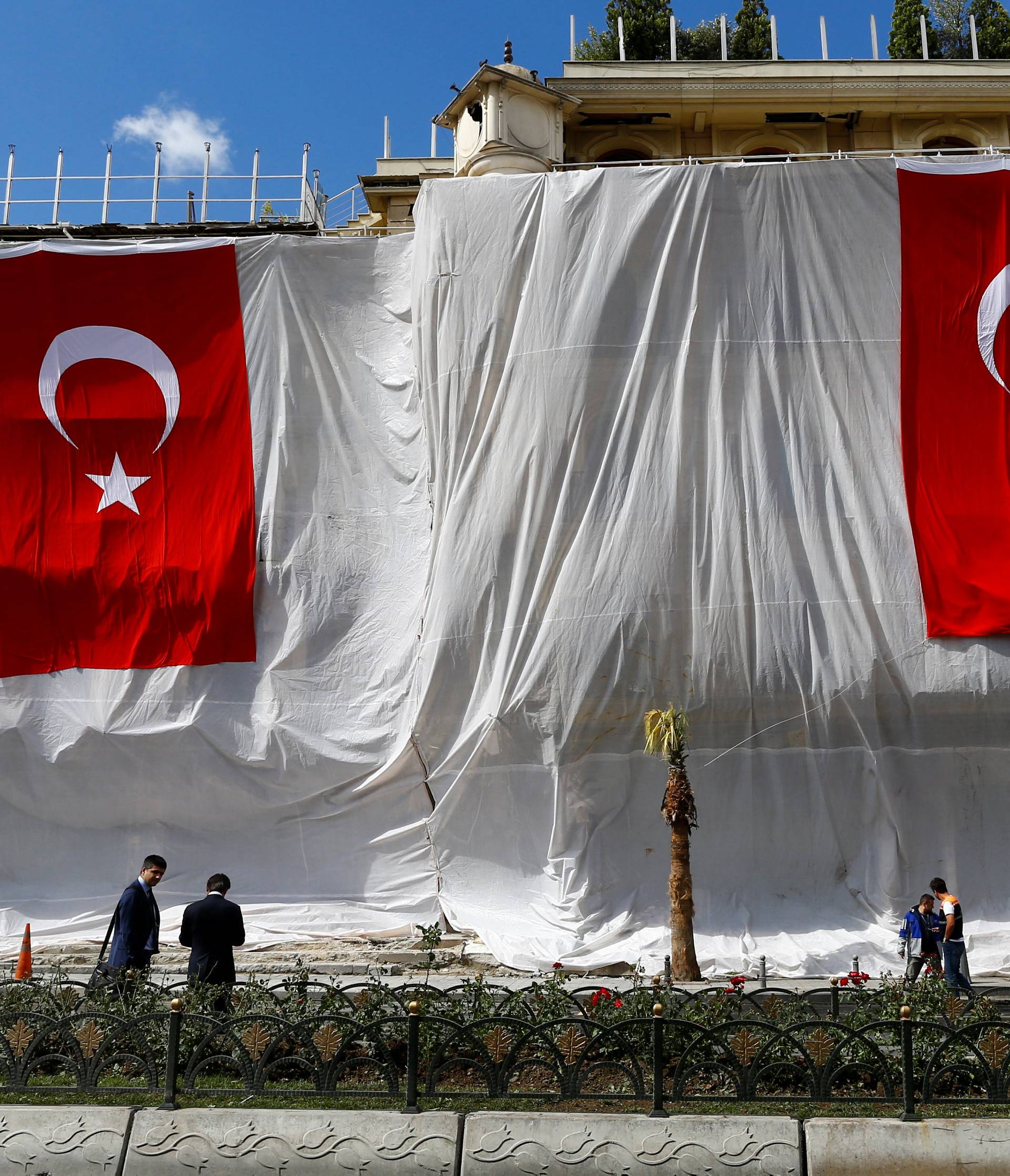 Buildings are seen covered and decorated with Turkish flags after Tuesday's car bomb attack on a police bus, in Istanbul