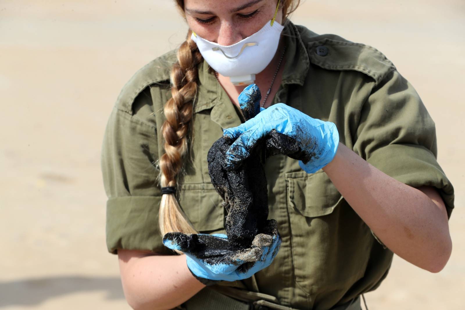 Israel's beaches blackened by tar after offshore oil spill