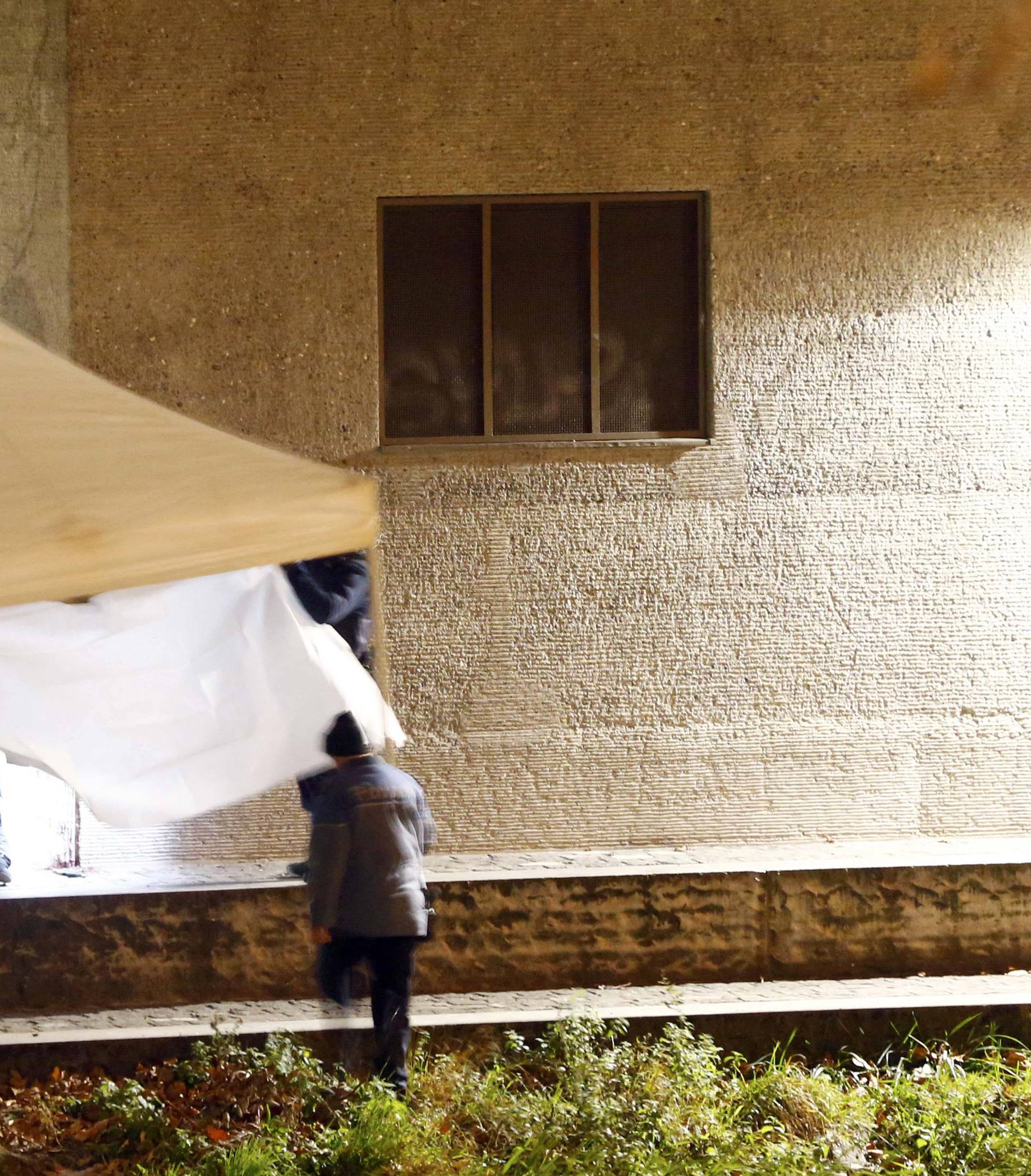 Police cover a body after a shooting outside an Islamic center in central Zurich