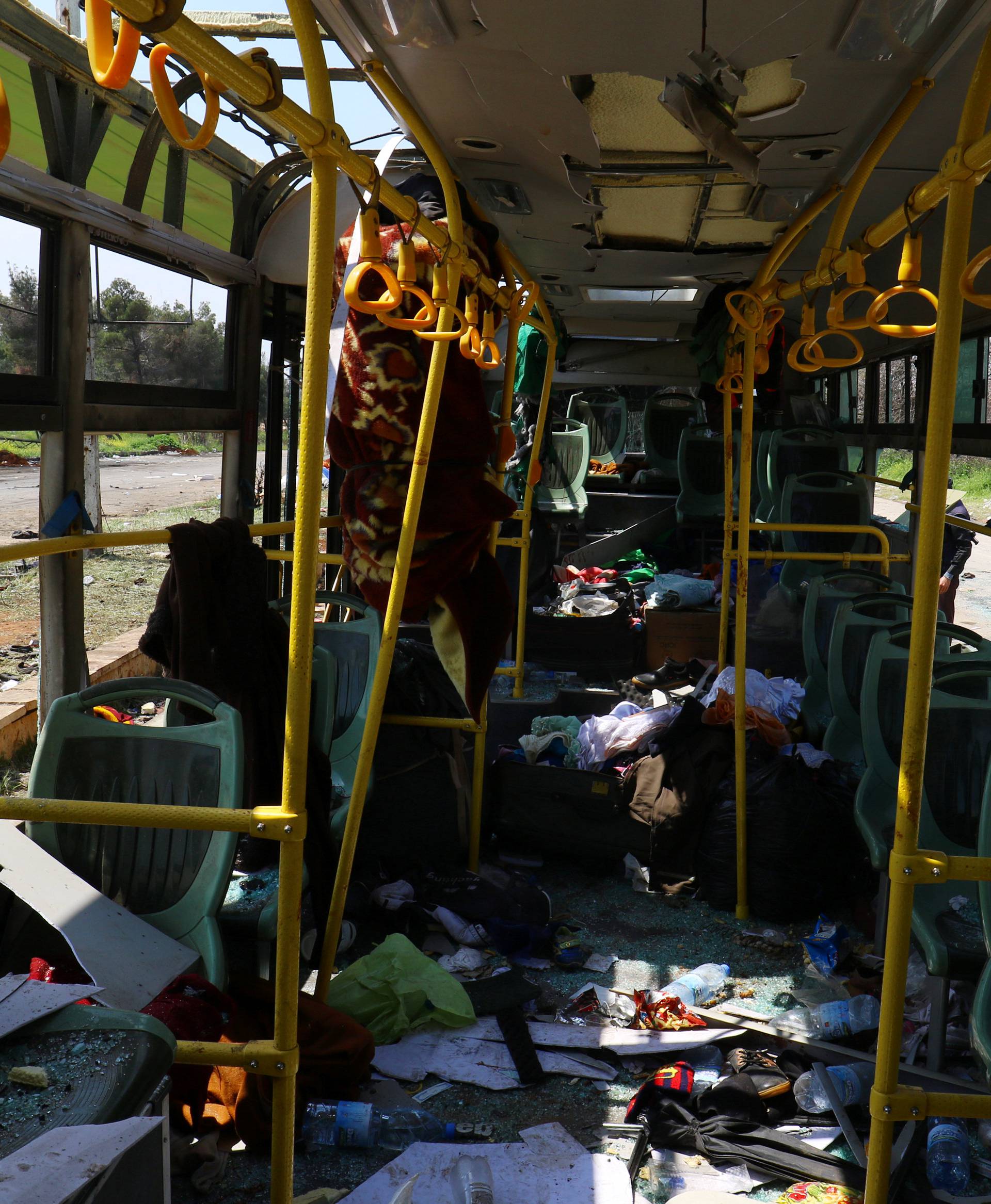 The interior of a damaged bus is seen after an explosion yesterday at insurgent-held al-Rashideen