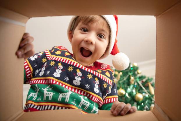 Happy,Surprised,Caucasian,Little,Boy,In,Santa's,Hat,Looking,Inside