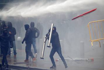 Far-right supporter throws a barricade during a protest against Marrakesh Migration Pact in Brussels