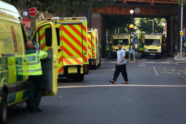 Ambulances gather near to the scene of a serious fire in a tower block at Latimer Road in West London