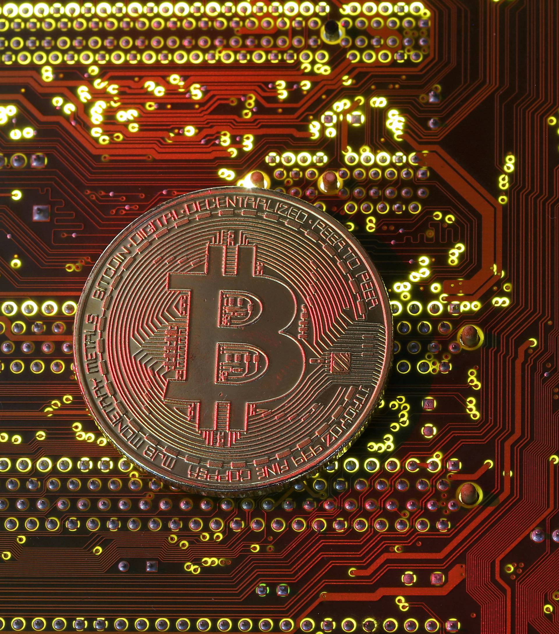 FILE PHOTO: A copy of bitcoin standing on PC motherboard is seen in this illustration picture