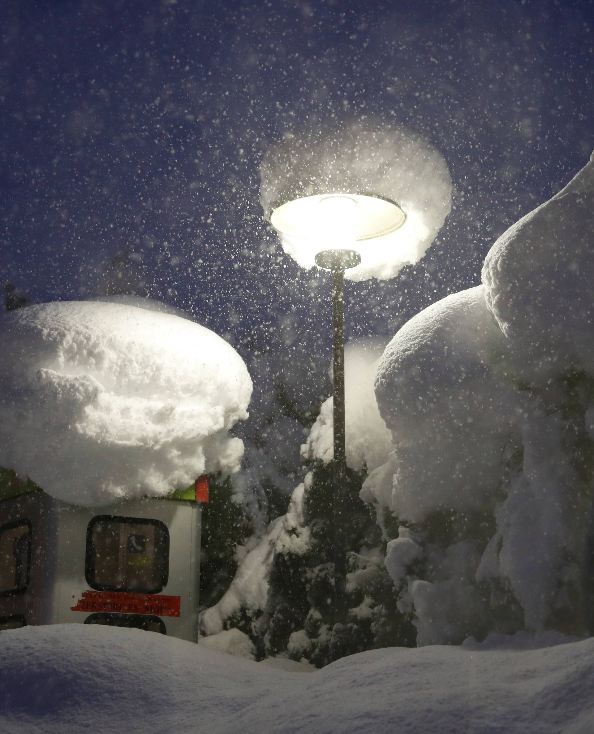 A phone booth is pictured during heavy snowfall in Reitdorf