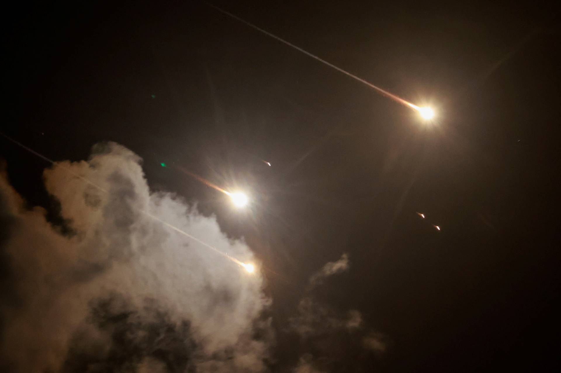 Projectiles are seen in the sky after Iran fired a salvo of ballistic missiles, amid cross-border hostilities between Hezbollah and Israel, as seen from Tel Aviv