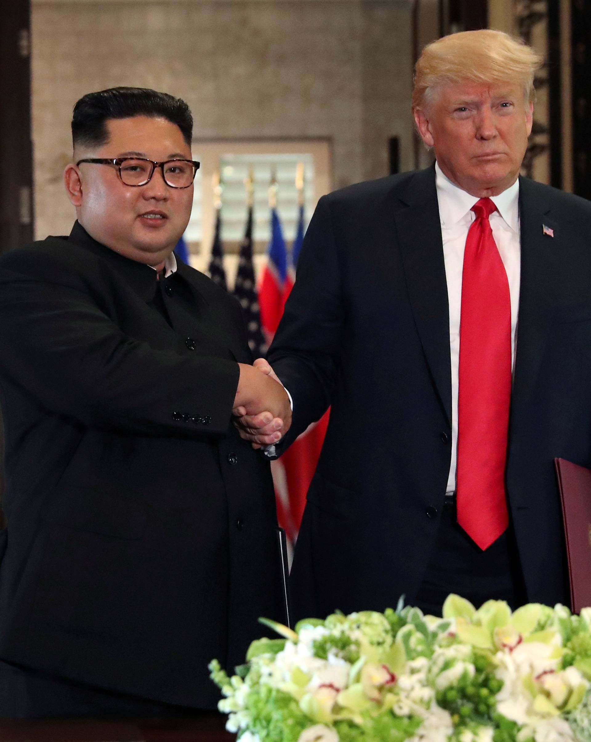 FILE PHOTO: U.S. President Donald Trump shakes hands with North Korea's leader Kim Jong after signed documents, after their summit in Singapore