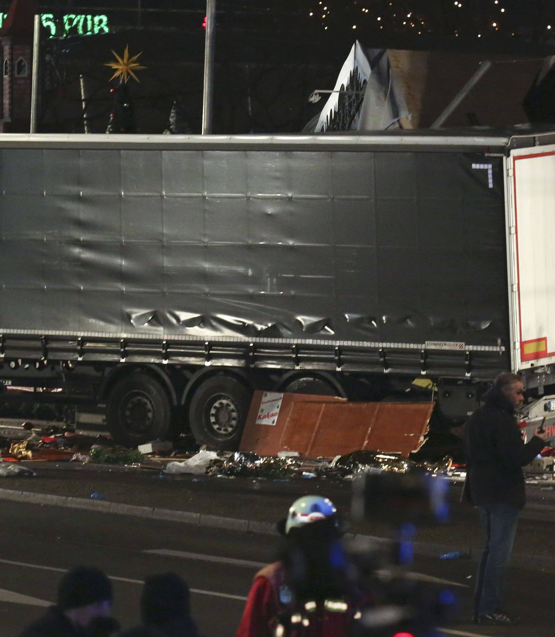 A German police officer looks into a truck at a Berlin Christmas market following an accident