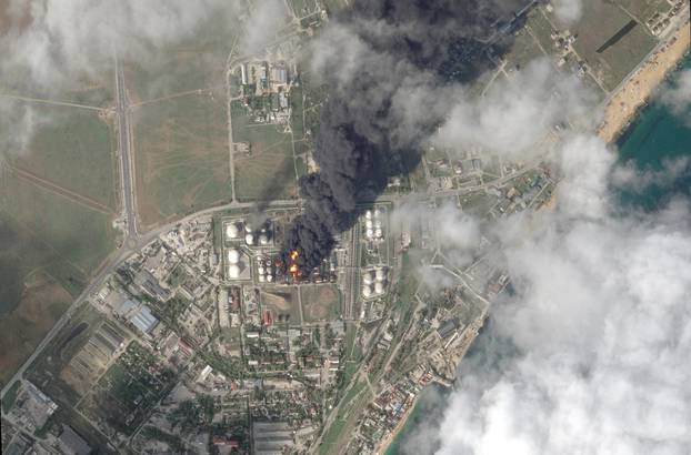 A satellite image shows fire and smoke rising from an oil depot in Feodosia