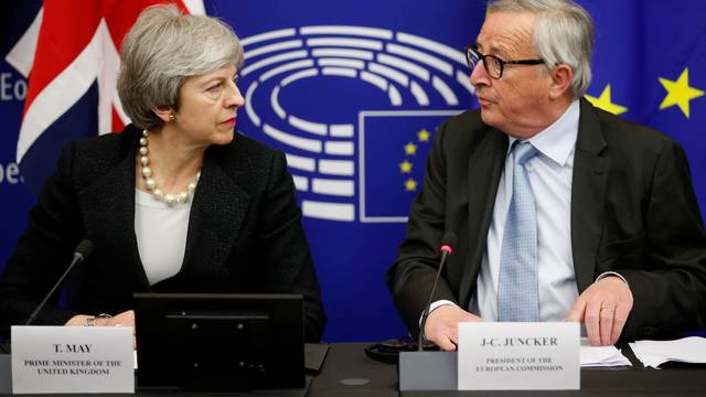 British Prime Minister Theresa May and European Commission President Jean-Claude Juncker look at each other during a news conference in Strasbourg
