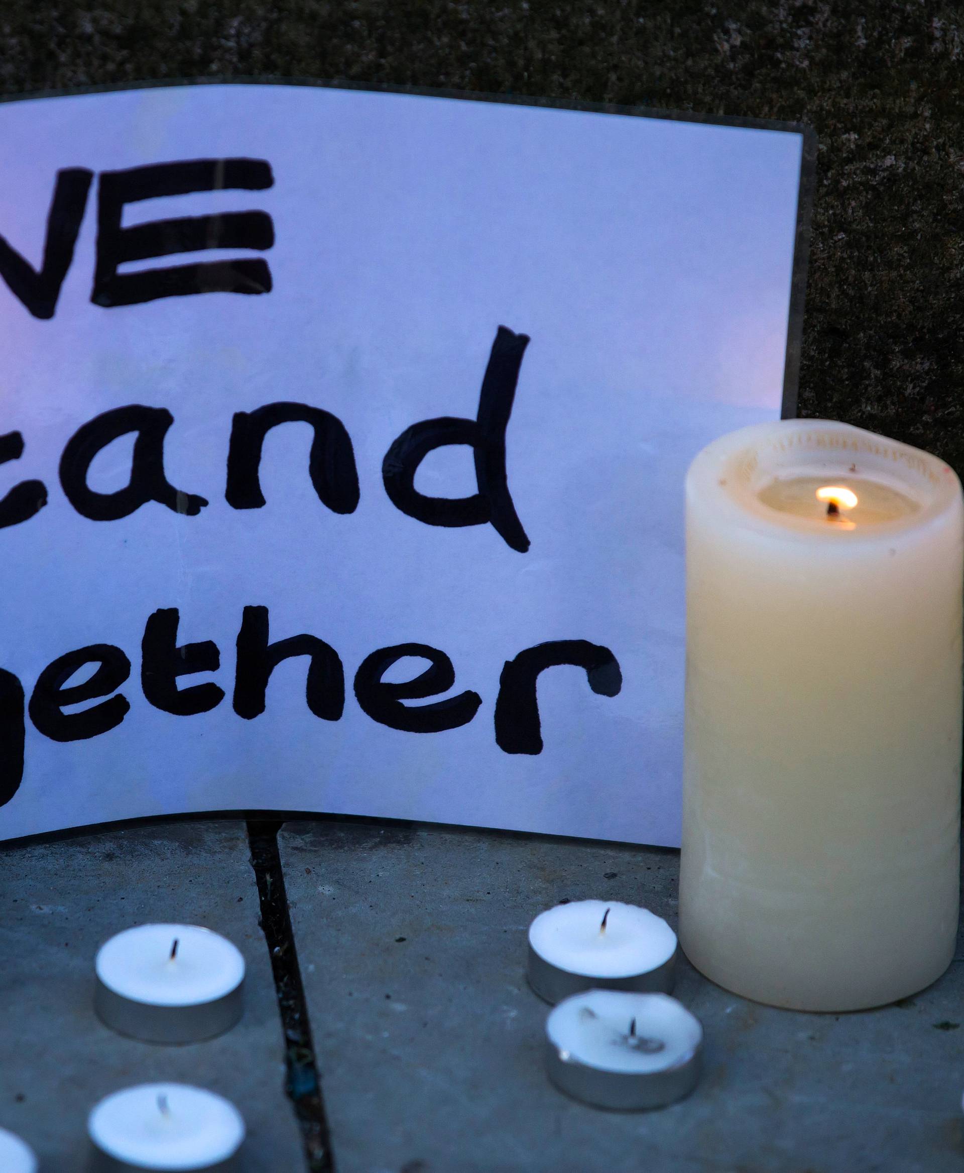 Candles and a message of condolence are left for the victims of the Manchester Arena attack in central Manchester, Britain