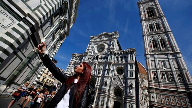 FILE PHOTO: Tourist takes selfie in Florence