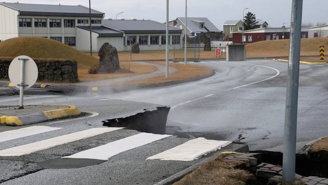 A road is damaged in the village of Grindavik, which was evacuated due to volcanic activity.