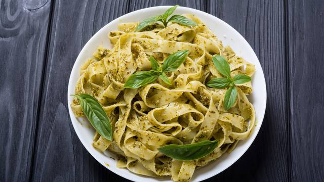 Pasta tagliatelle with green sauce pesto . Italian food backgrou