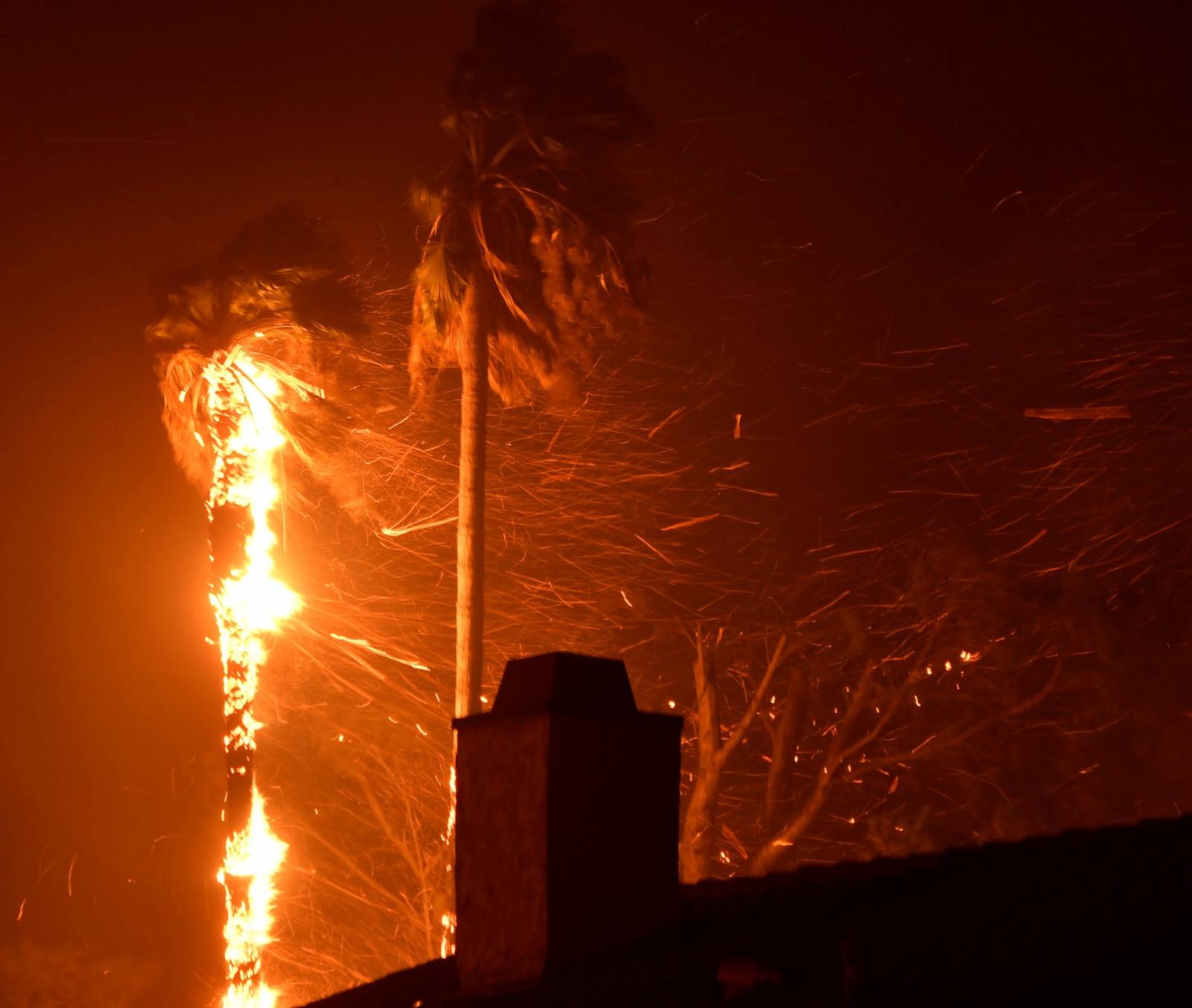 Flying embers fill the night sky to the ground from a wind-driven wildfire called the Saddle Ridge fire in the early morning hours Friday in Porter Ranch