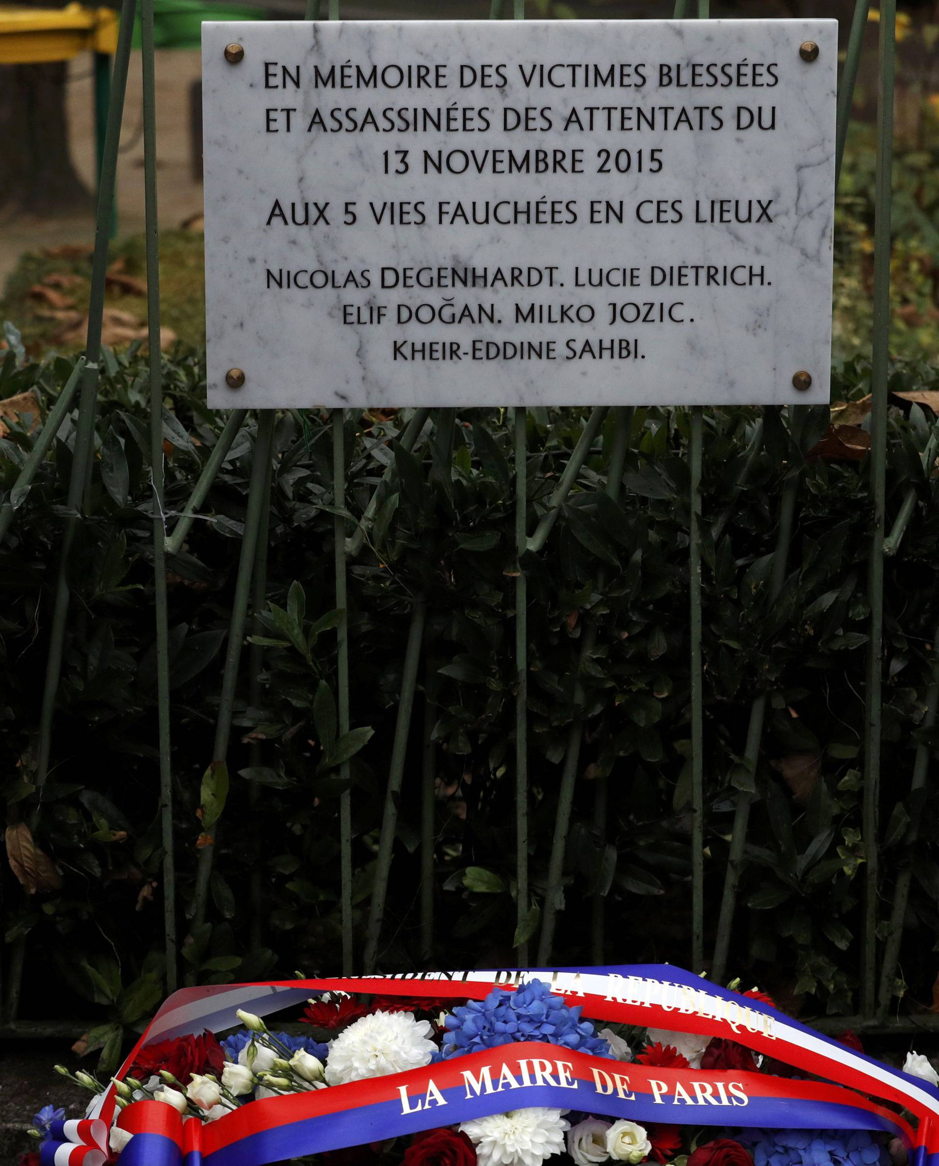 French President Francois Hollande and Paris Mayor Anne Hidalgo unveil a commemorative plaque next to the "A La Bonne Biere" cafe