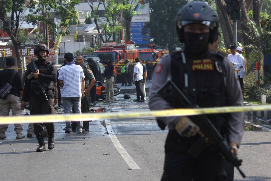 Police stand guard near the site of a blast at the Pentecost Church Central Surabaya (GPPS), in Surabaya, East Java