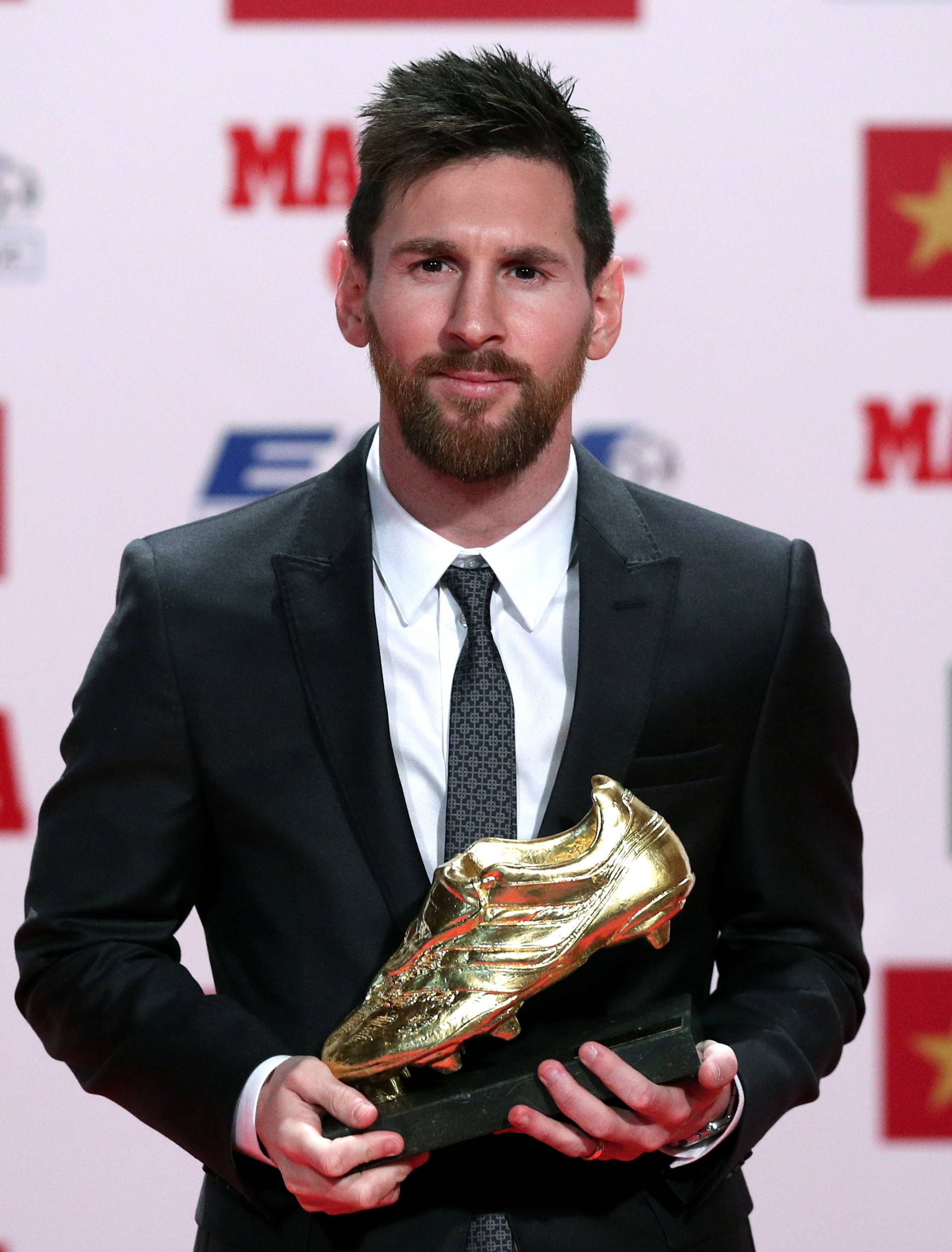 Barcelona's Lionel Messi poses with his Golden Boot trophy during a ceremony in Barcelona
