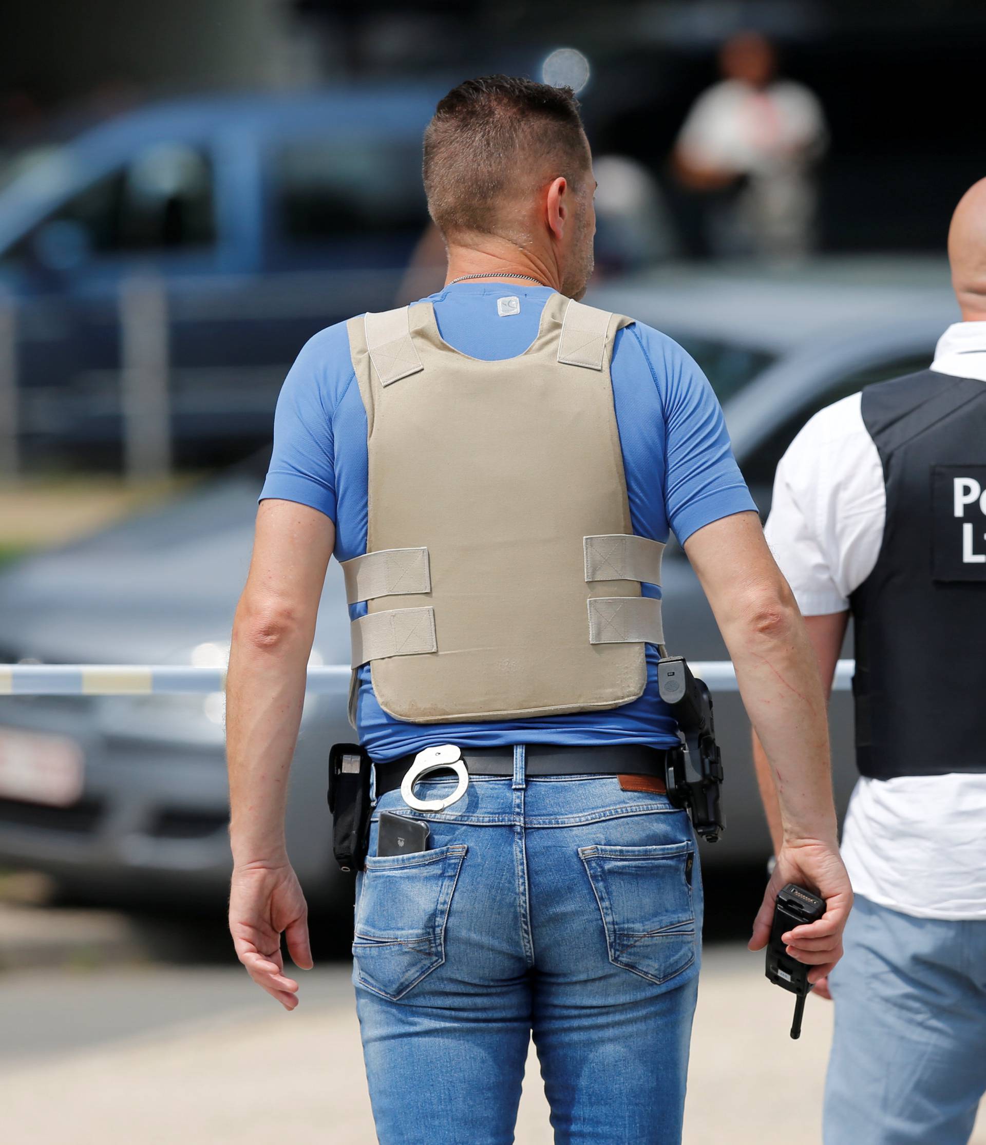 Police officers are seen on the scene of a shooting in Liege