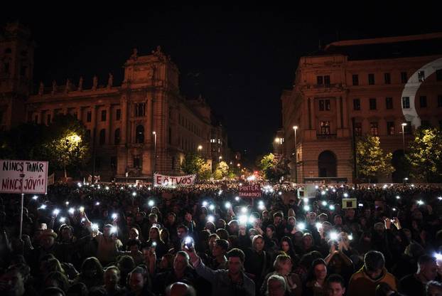 People light up their mobile phones during a protest in support of teachers fighting for higher wages and teachers sacked for protesting, in Budapest