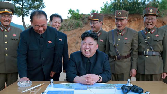 FILE PHOTO: North Korean leader Kim Jong Un reacts during the long-range strategic ballistic rocket Hwasong-12 (Mars-12) test launch