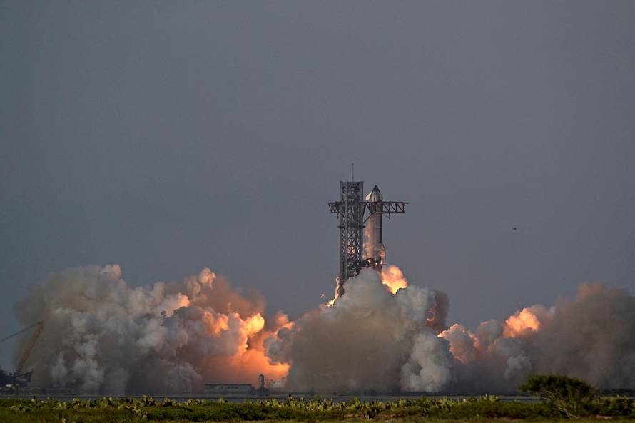 A SpaceX Super Heavy booster carrying the Starship spacecraft lifts off on its 10th test flight