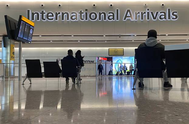 Travellers are seen at an arrivals area of a terminal at Heathrow Airport, amid the spread of the coronavirus disease (COVID-19) pandemic, London, Britain