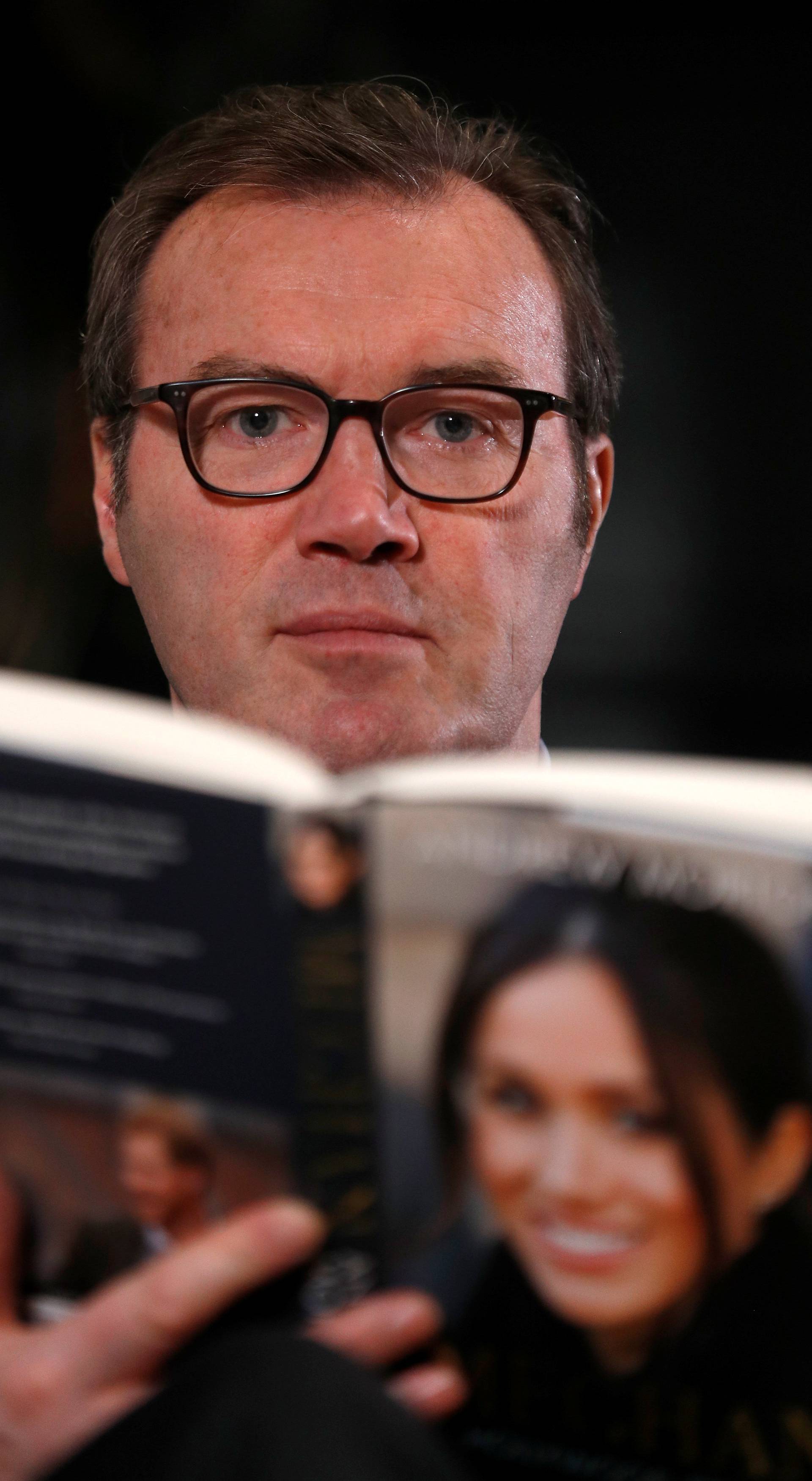 Royal biographer Andrew Morton holds his most recent book, a biography of Meghan Markle, following an interview with Reuters journalists in London