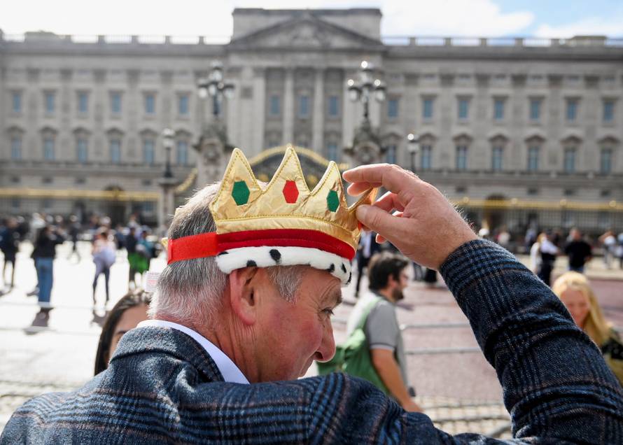 People gather outside Buckingham Palace in London