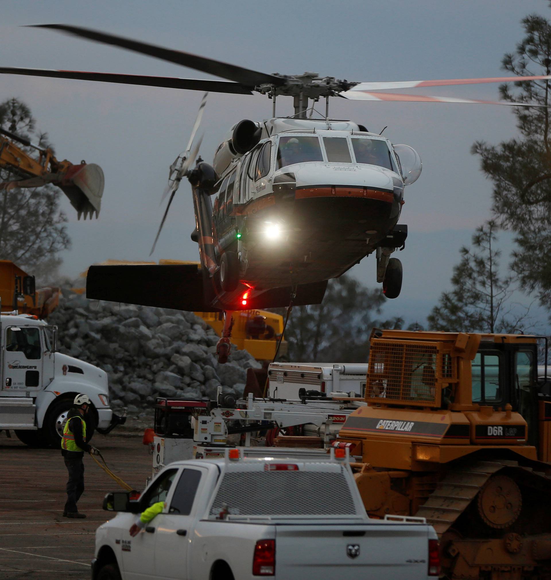 A helicopter used for hauling rocks takes off near the Lake Oroville Dam after an evacuation was ordered for communities downstream from the dam in Oroville, California, U.S.