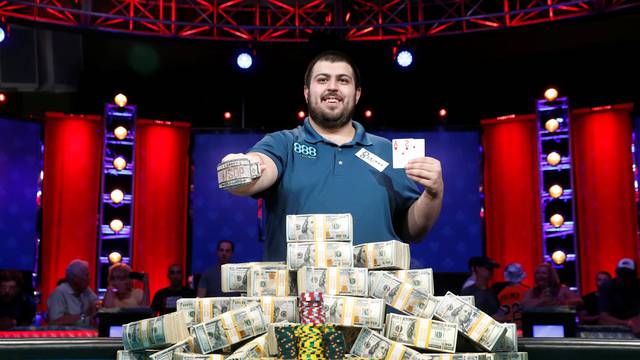 Scott Blumstein of the U.S. poses with his championship bracelet and cards after winning the World Series of Poker Main Event in Las Vegas