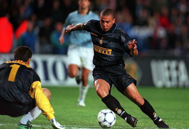 Inter Milan striker Ronaldo rounds Lazio goalkeeper Luca Marchegiani before slotting home into an open net to seal a 3-0 win in the UEFA Cup final.