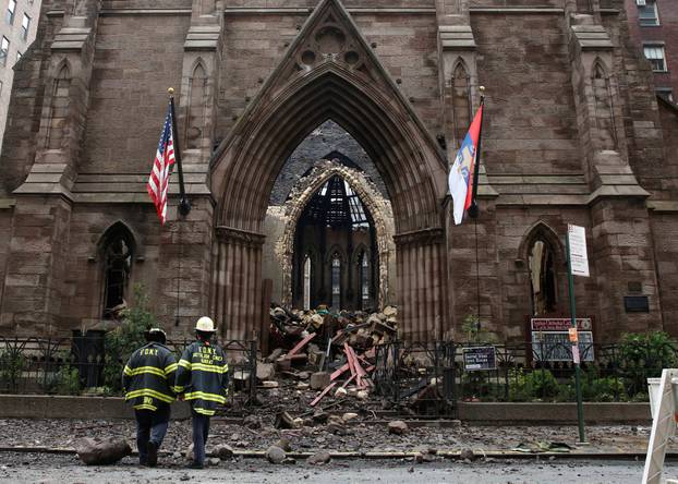 New York City firefighters (FDNY) walk through the debris following a fire at Manhattan