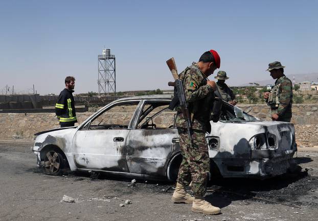 Afghan security forces inspect car after a suicide bomb blast in Paktia Province