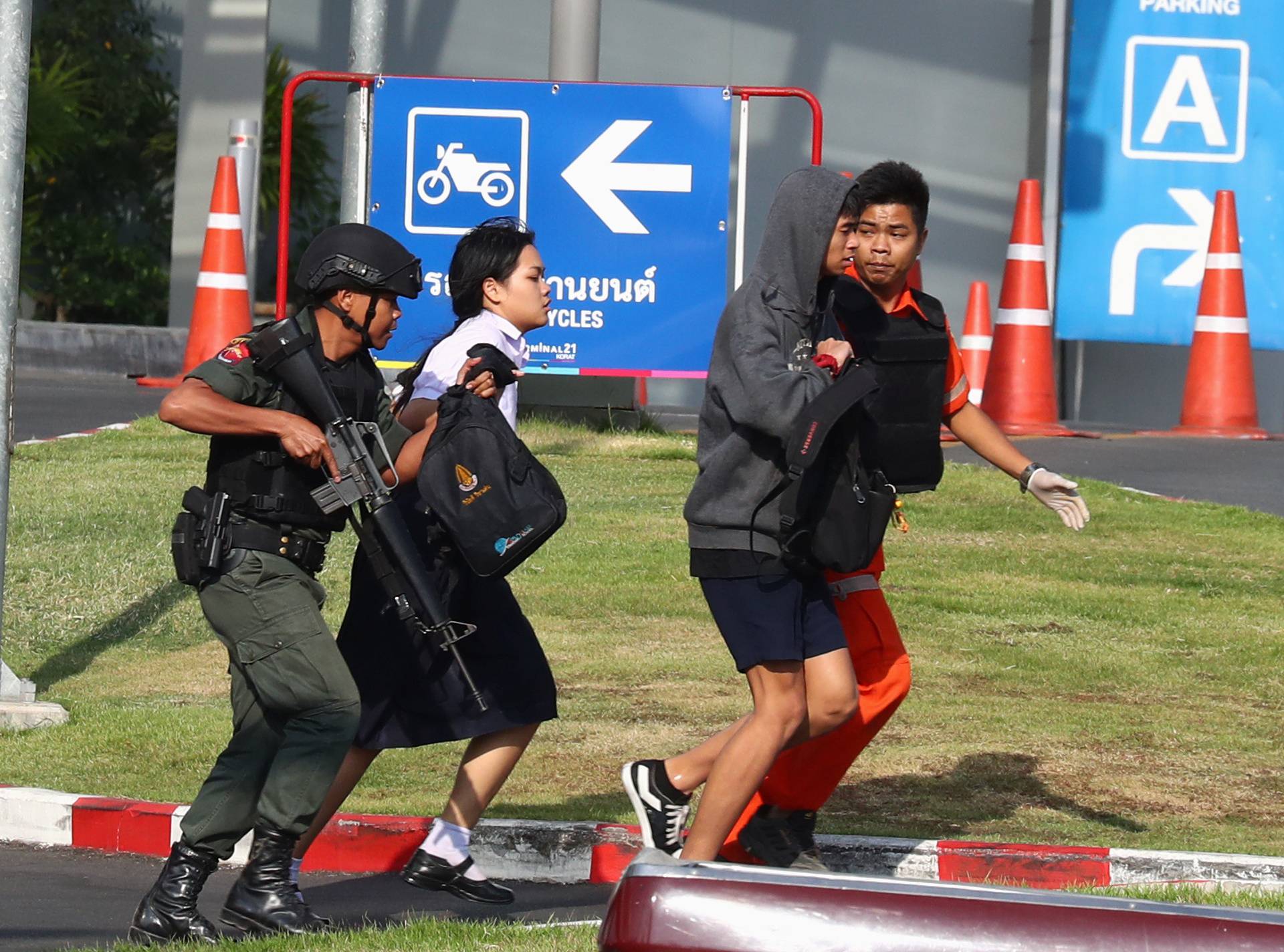 Thai security forces evacuate students stranded inside the Terminal 21 shopping mall following a gun battle to try to stop a soldier on a rampage after a mass shooting, Nakhon Ratchasima