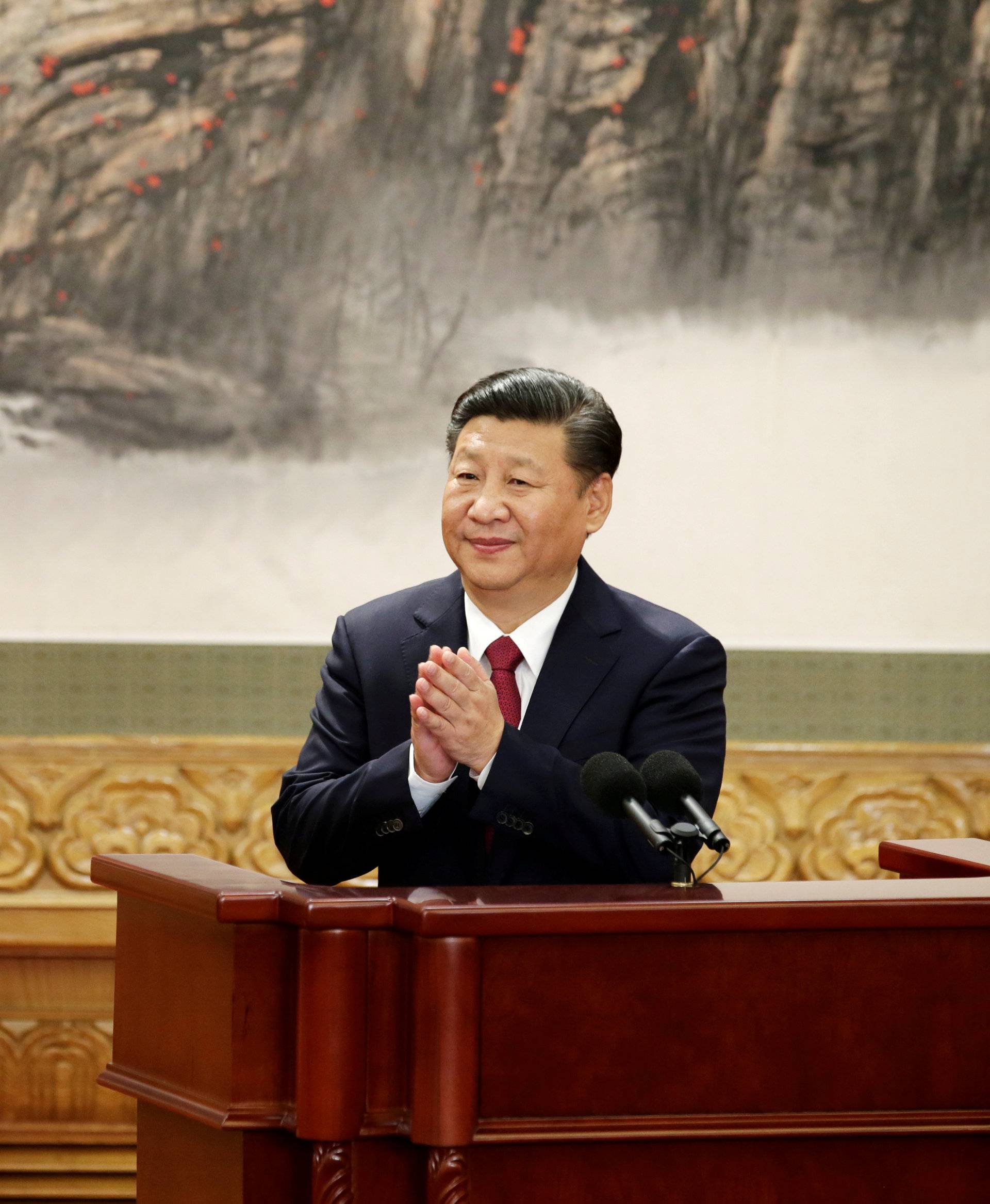 FILE PHOTO: Chinese President Xi Jinping claps after his speech as China's new Politburo Standing Committee members meet with the press at the Great Hall of the People in Beijing
