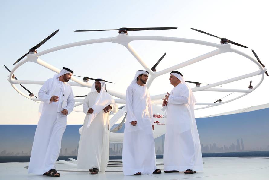 Dubai Crown Prince Sheikh Hamdan bin Mohammed bin Rashid Al Maktoum stands in front of the flying taxi in Dubai