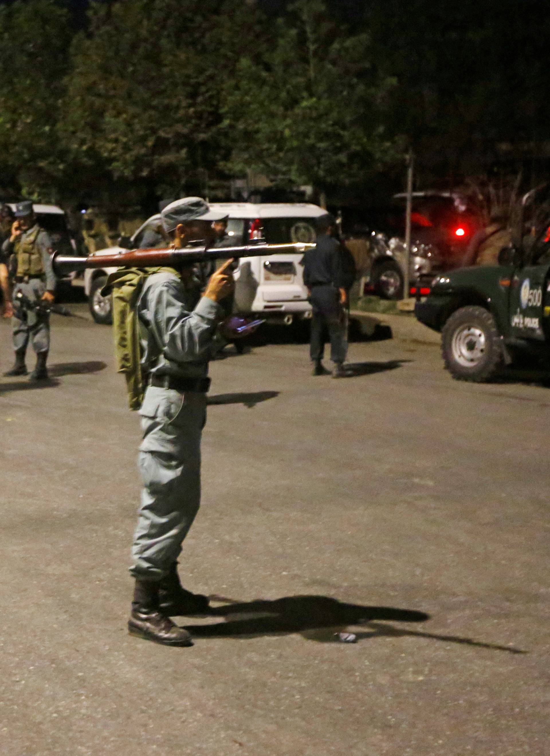 Afghan policemen stand guard at the site of an attack at American University of Afghanistan in Kabul