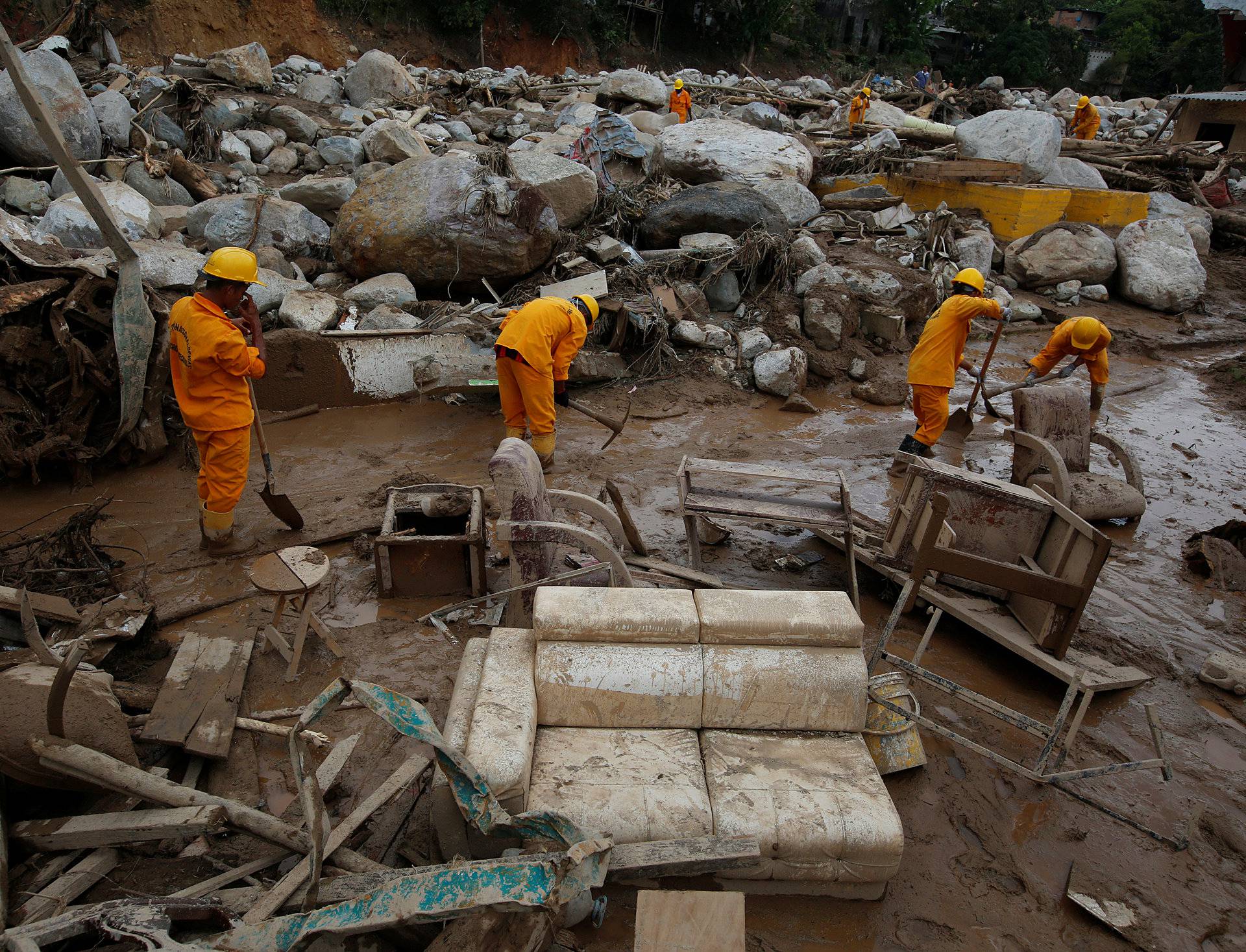 Rescuers look for bodies in a destroyed area, after flooding and mudslides caused by heavy rains leading several rivers to overflow, pushing sediment and rocks into buildings and roads, in Mocoa