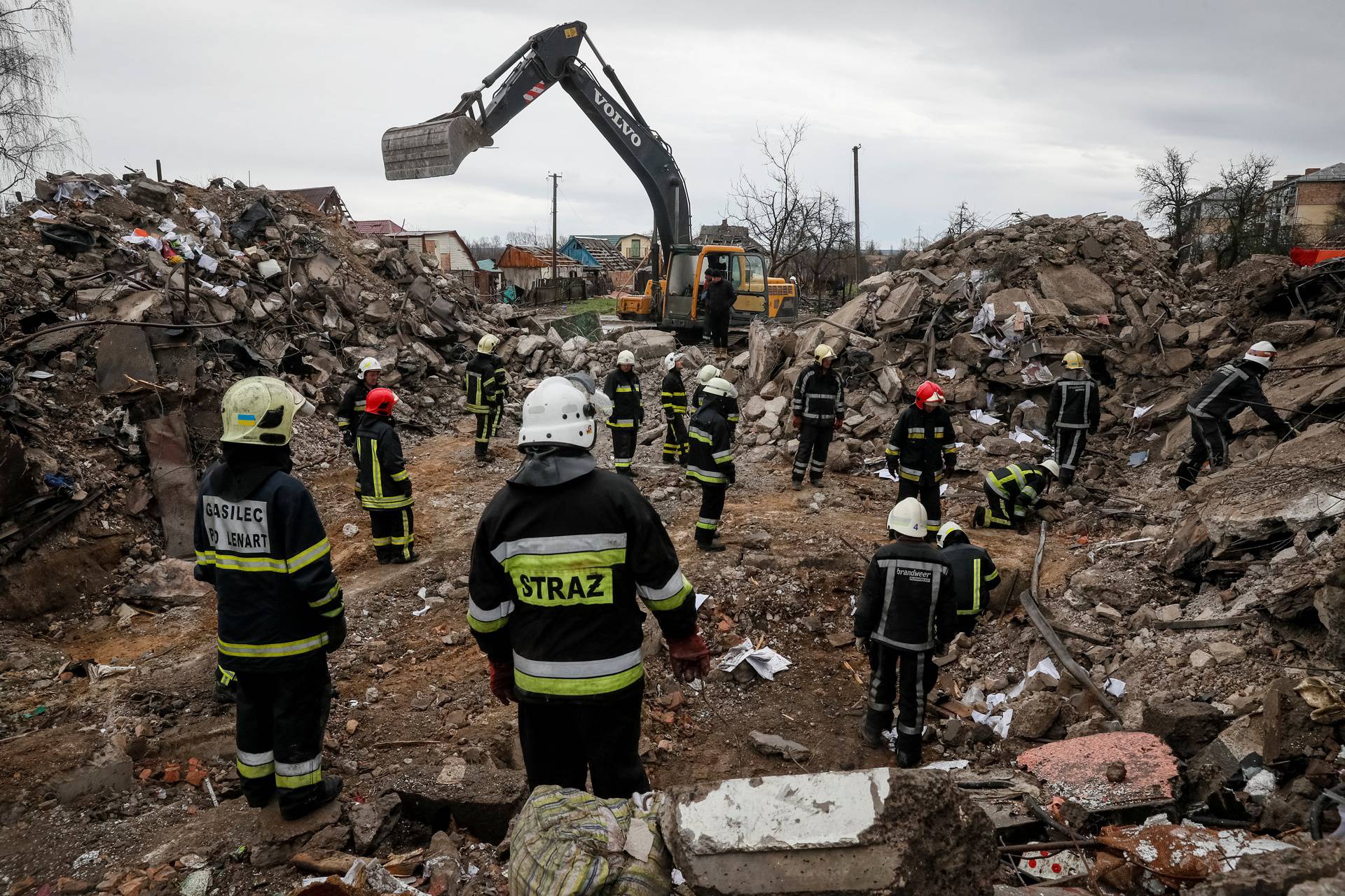 Rescuers work among remains of a residential building destroyed by Russian shelling in Borodyanka